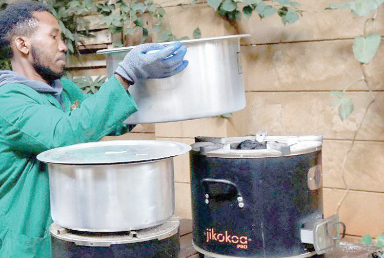 A worker performs a demonstration of clean cookstoves in Ruiru, Kiambu.