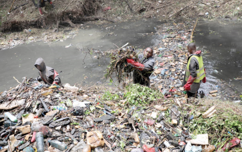 Young people clean up a section of the Nairobi River at the Michuki  Memorial Park in Nairobi on August 21, 2023 in a programme funded by the national government and UNEP.