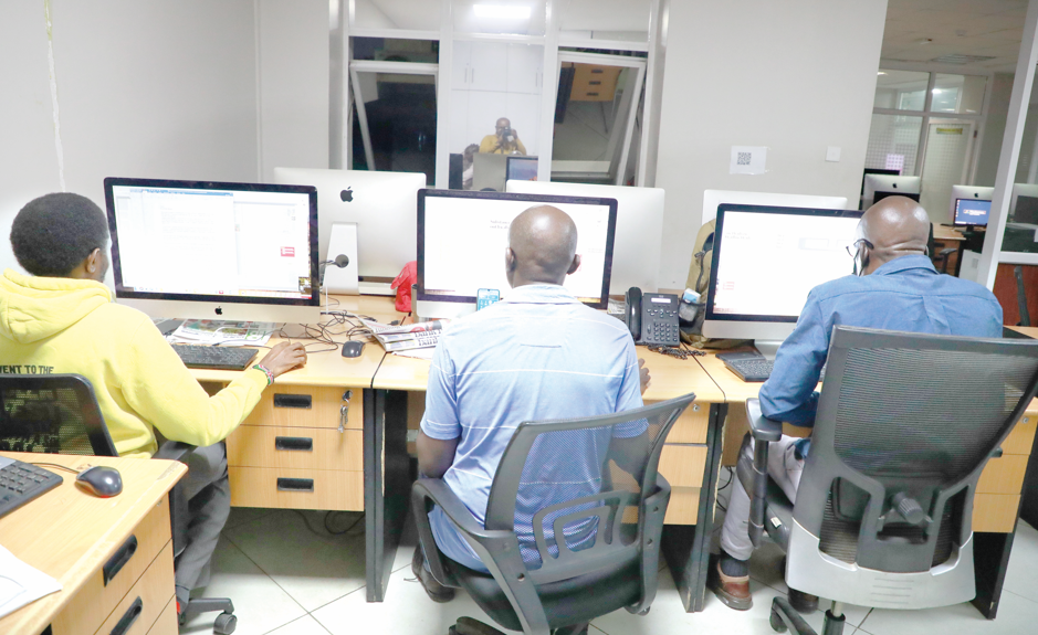 From left, People Daily sub-editors Peter Ndoria, Derek Otieno and Henry Gekonde assembling the final print edition of People Daily newspaper in Nairobi, yesterday. PHOTO/Bernard Malonza