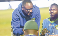 Menengai Oilers head coach Gibson Weru pep-talks his boys at half-time of the Floodies final. Oilers beat Impala 42-3 to bag their maiden 15s major trophy in Nairobi. PHOTO/ALEX NJUE