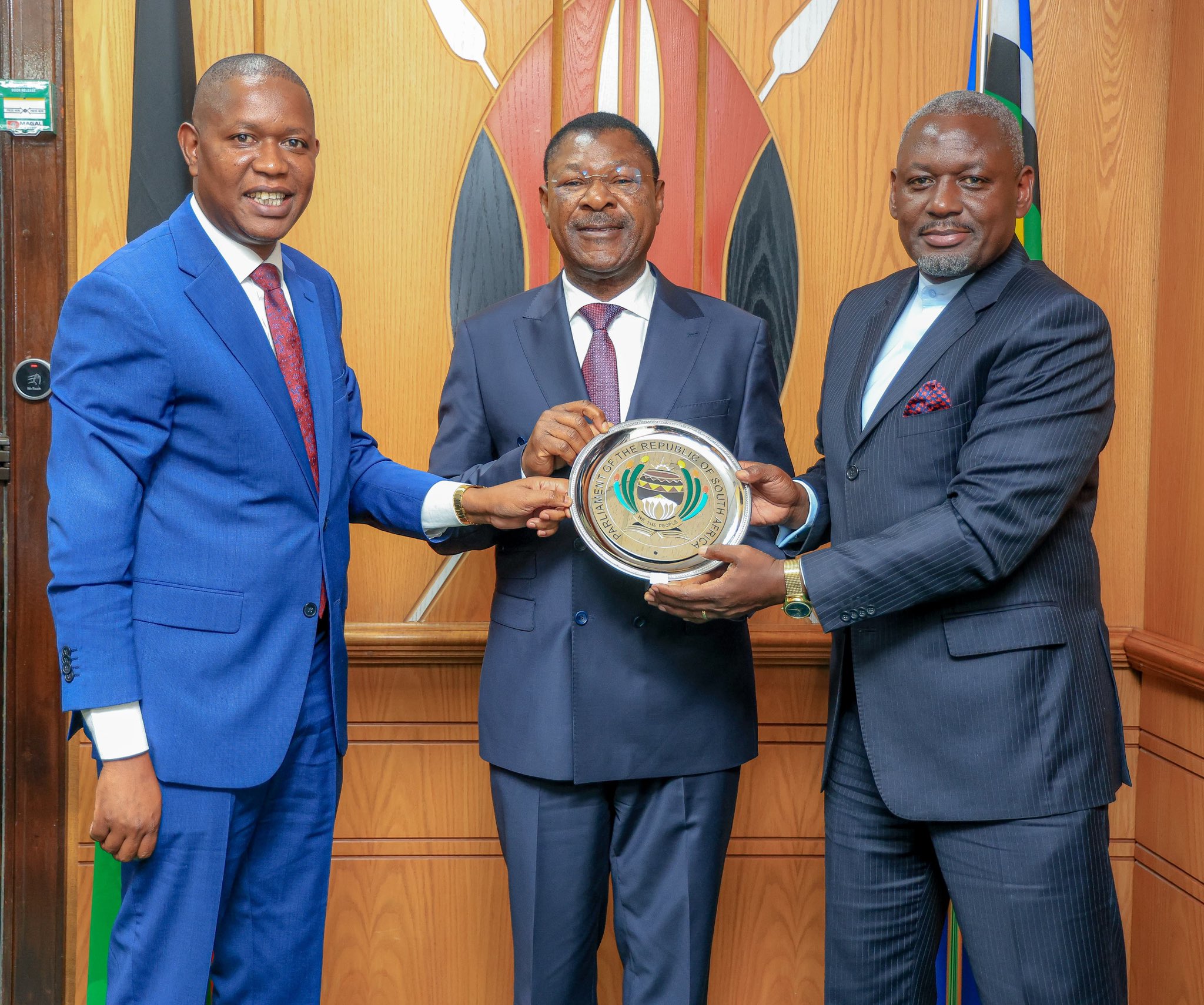 Kibwezi West MP Mwengi Mutuse and Rarieda MP Otiende Amollo present National Assembly Speaker Moses Wetang'ula with a commemorative plaque. PHOTO/@HonWetangula/X