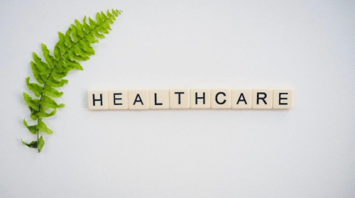 A graphic representation of the word healthcare on a white surface. PHOTO/Pexels