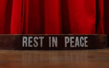 A red curtain with the words Rest in peace. Image used for representation only. PHOTO/Pexels