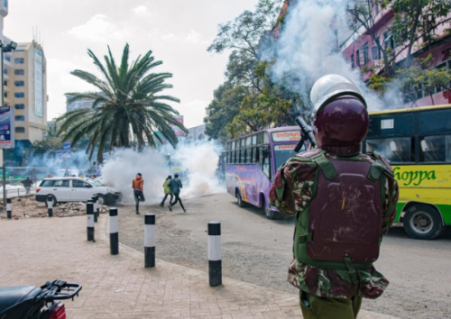 A police officer lobs teargas on protesters in Nairobi on July 24, 2024. PHOTO/@SemaUkweliKenya/X
