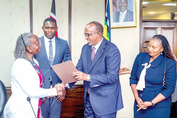 Health Cabinet Secretary Aden Duale officially mandates Prof Elizabeth Bukusi (left) and her committee. Looking on is Medical Services PS Ouma Oluga and his Public Health counterpart Mary Muthoni. PHOTO/MOH