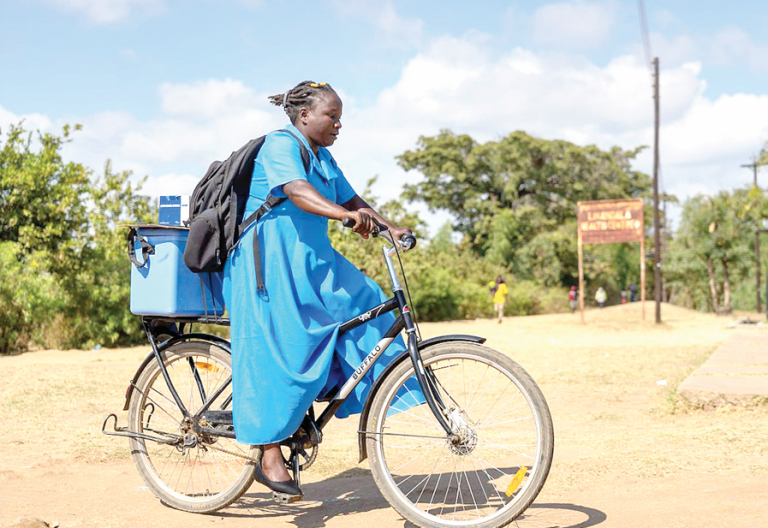 Community Health Volunteer riding a bicycle. PHOTO/Print