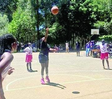 Calvary ladies basketball team players (donning white and red jerseys) watch in readiness for a rebound as an opponent team player makes free throw during a recent league game. PHOTO/EWBL