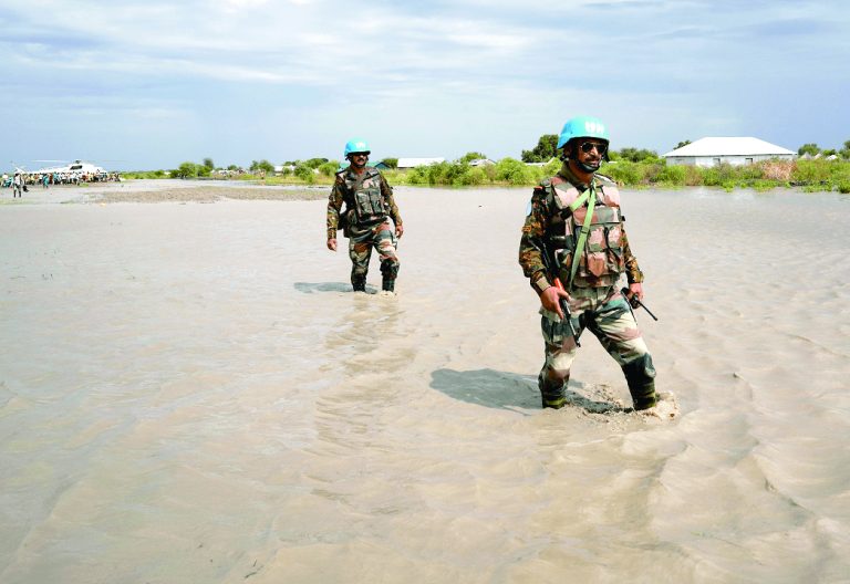 UN peacekeepers walk through water in Boma state, South Sudan, after heavy rains and floods forced hundreds of thousands of people to leave their homes. PHOTO/REUTERS/Andreea Campeanu