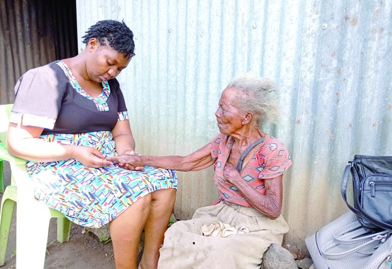 Joyce Mumbi with Pelisina Wanjiru, an elderly woman from Matithi, when she paid the old lady a visit at her home.  PHOTO/Wangari Njuguna