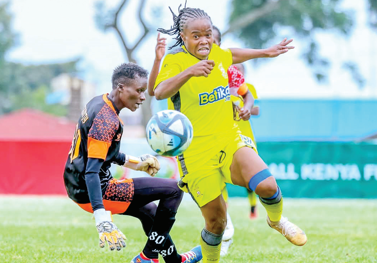 Rebecca Okwaro of Kenya Police Bullets (right), beats Trinity acc goalkeeper to score acc their final Women Premier League match last weekend. PHOTO/ SportPicha