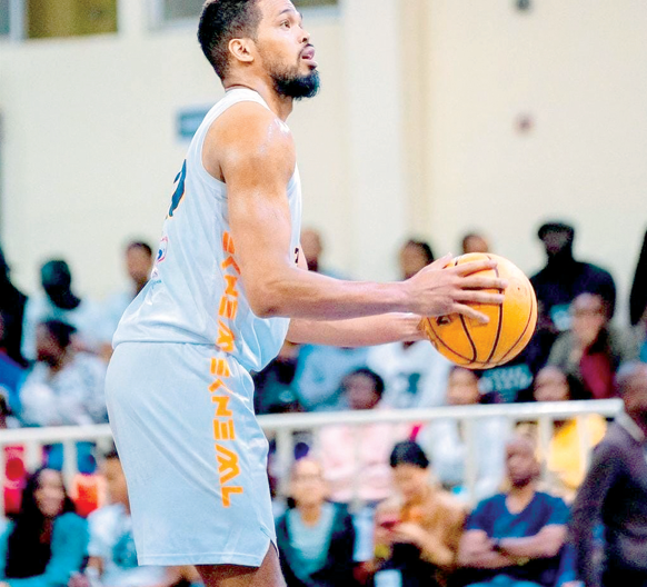 Nairobi City Thunder (NCT) basketball team import player William Sydney Davies ll prepares to dunk a 3- pointer score. PHOTO/NCT