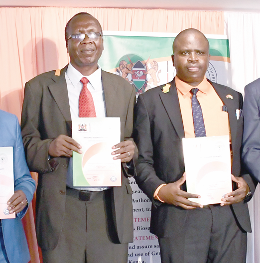 Eng Laban Kiplagat representing Agriculture PS Dr Paul Rono (left) and National Biosafety Authority acting Chief Executive Officer, Nehemiah Ng’etich display a copy of the authority’s Strategic Plan 2023-2027 during its launch in Nairobi, yesterday. PHOTO/PHILIP KAMAKYA