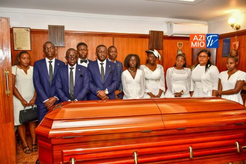 The late Charles Were's family standing in front of the coffin. PHOTO/@TheODMparty/X