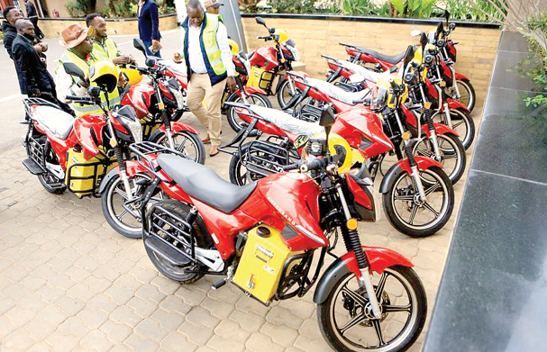 People look at the electric motorbikes during the launch of an e-bike project in Nairobi, capital of Kenya, on July 5, 2023. PHOTO/Print