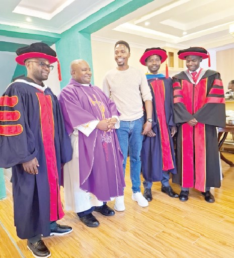 From left: Xavier Musonye, Fr Rev Erambo (Olympia Musonye (Ph.D candidate), Harry Musonye and Fenwicks Musonye at a thanks giving/reception party held in Nairobi following the conferment of PhD to Harry Musonye. PHOTO/DOUGLAS DINDI
