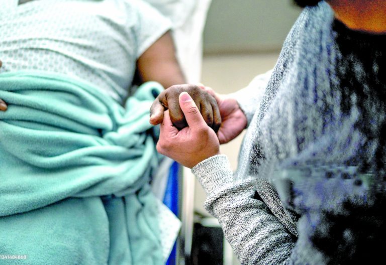Son holding father\'s hand at the hospital. Image used for representational purposes only. PHOTO/Pexels