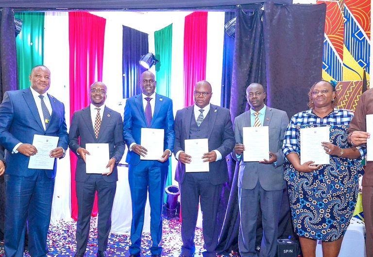 Internal Security PS Raymond Omollo (centre) joins other guests in displaying a copy of the Draft Public Benefit Organisations Act Regulations, 2025, in Nairobi when he presided over its launch at the Kenya Institute of Curriculum Development on Thursday June 5, 2025. PHOTO/Bernard Malonza