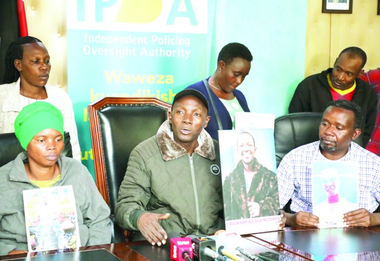 The families of some of the young people killed last year during anti-government protests hold the portraits of their departed relatives at the police oversight agency IPOA’s offices in Nairobi in July last year. PHOTO/Bernard Malonza