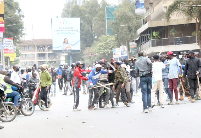 A trader is robbed of his personal belongings by goons said to have been hired by well-connected politicians, along Moi Avenue in Nairobi. PHOTO/Kenna Claude