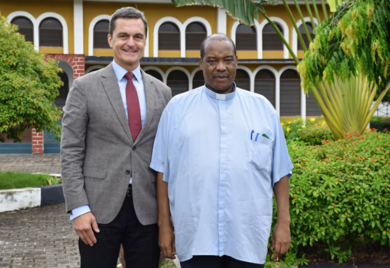 Chargé d’Affaires in the US embassy in Tanzania, Andrew Lentz poses with Father Charles Kitima. PHOTO/@usembassytz/X