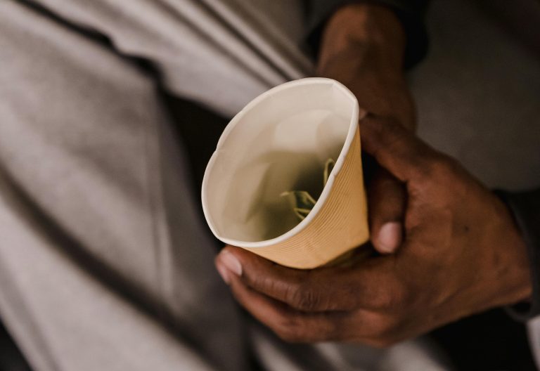 A homeless person holding a cup with money. Image used for representational purposes only. PHOTO/Pexels
