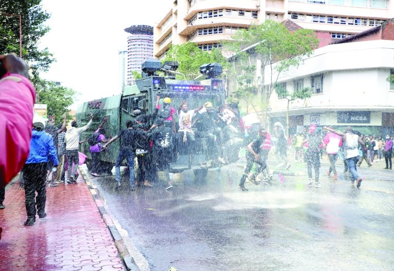 Anti-riot police officers confront protesters outside City Hall in Nairobi as Kenyans protested over last year’s Finance Bill. PHOTO/Bernard Malonza