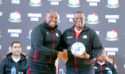 PG 32 Kenya's Sports Cabinet Secretary Salim Mvurya receives a ball Harambee Stars coach Benni McCarthy at Kasarani Stadium on July 10 2025 ahead of the 2024 CHAN tournament