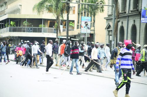 Hired goons clear a section of Moi Avenue in Nairobi that was barricaded by protesters on June 18, 2025, demanding the resignation of a police boss. PHOTO/Bernard Malonza
