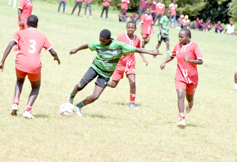 Girls action between defending champions Kinale of Kiambu (in red) and Ruiru of Nyandarua (green) during their football final of the Central Region Secondary Schools Term Two games played at Ndururumo High school ground in Nyahururu at the weekend. PHOTO/David Macharia