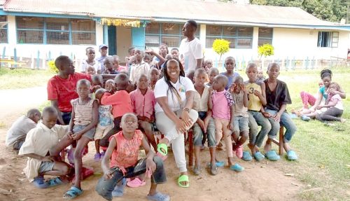 Maryanne Achieng’ in a photo with children at one of the Children homes in Bungoma. PHOTO/Tony Wafula