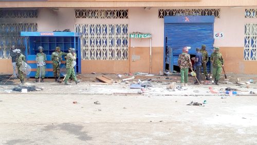 Police officers outside a retail shop that was vandalied by goons in Kabati, Murang’a South, during Saba Saba protests on Monday, July 7, 2025. PHOTO/Wangari Njuguna