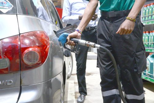 A petrol station attendant fuels a vehicle in Nairobi yesterday as Kenyans cry foul over the steep increase of fuel prices in the country. PHOTO/John Ochieng