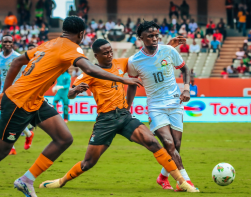 Harambee Stars midfielder Austin Odhiambo (in white) battles for the ball with Zambian players on August 17, 2025. PHOTO/@Harambee_Stars/X
