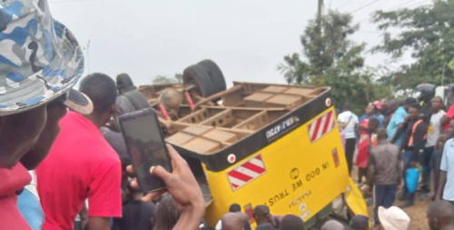 Kisumu residents mill around the wreckage of a school bus involved in an accident along the Kisumu-Kakamega highway on Friday, August 8, 2025. PHOTO/https://web.facebook.com/profile.php?id=100063981851831