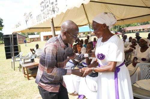 Ugunja Aspirant Moses Omondi while conferring with a resident of Ugunja during the burial of Francisca Awuor Maga. PHOTO/Eric Juma