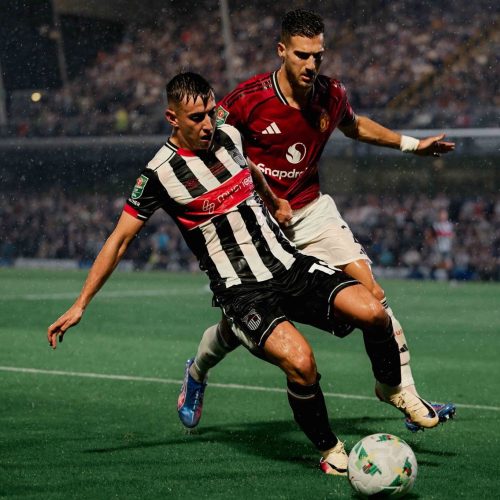Diogo Dalot of Manchester United challenges a Grimsby Town player. PHOTO/@officialgtfc/X