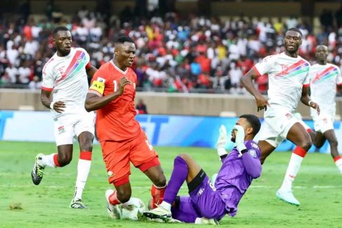 Harambee Stars captain Michael Olunga vies for the ball against Gambian goalkeeper in a World Cup Qualifiers match at Kasarani Stadium on Friday, September 5, 2025. PHOTO/https://www.facebook.com/100063913291982/posts/pfbid02ZY1d92h87ngqZvK31h8rnEq4M8iaqQSiEuBnMCF4oVRY9ywLwDB66ugHR1AuCnDgl/?app=fbl