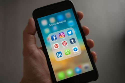 A person holding an iPhone displaying social media apps.Image used to illustrate the story.PHOTO/Pexels