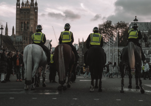 Police officers on horseback guarding the streets of London in front of the Houses of Parliament. PHOTO/Pexels