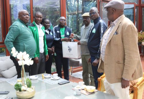 Former Prime Minister Raila Odinga handing over a gift to Gor Mahia officials: PHOTO/facebook.com/GorMahiafcofficial