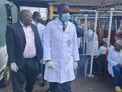 Tom Nyakaba (with the mask) during a sanitation exercise at Burma Market. PHOTO/https://www.facebook.com/Tom Michira Nyakaba