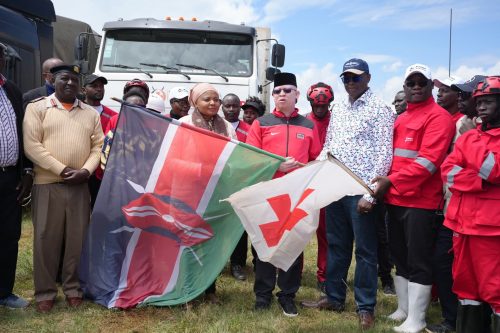 Isaac Mwaura waves the Kenyan flag in front of trucks loaded with relief supplies destined for families affected by the Elgeyo Marakwet mudslide. PHOTO/@MwauraIsaac1/X