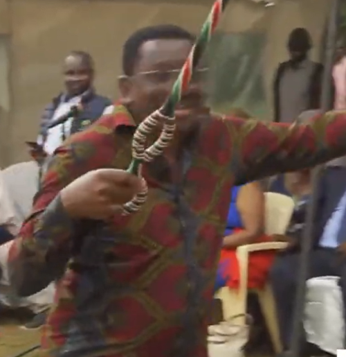 Orengo filled with Joy after being given a walking stick by Kamba elder. PHOTO//Screengrab by People Daily