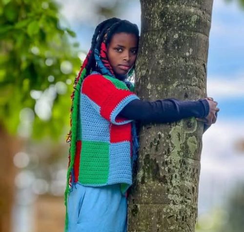 Truphena Muthoni hugging a tree: PHOTO/.facebook.com/GovernorKahiga