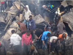Firefighters and residents work to contain the flames. PHOTO/Screengrab by People Daily Digital