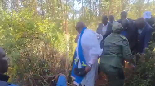 One of Rigathi Gachagua's bodyguards disguises as a priest, as they escape through a fence during the church chaos in Othaya on Sunday, January 25, 2026. PHOTO/Screengrab by People Daily Digital