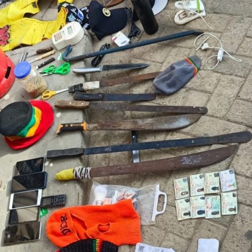 Recovered items, including machetes and IDs, displayed by police. PHOTO/@MohaJichoPevu/X