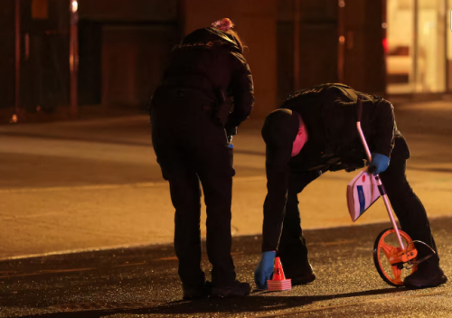 Law enforcement officials inspect evidence on the street after a shooting incident near the White House in Washington, D.C., U.S., May 23, 2026. PHOTO/Kylie Cooper/Reuters