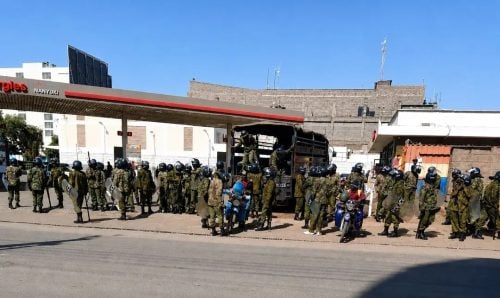 Police officers on standby along a street in Nanyuki, ready to respond and prevent further escalation during Tuesday’s protests. PHOTO/Wanjira Wachira