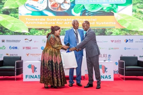 Charity Mutegi and Tharaka University Chancellor Ratemo Michieka presenting a gift to Livestock Development PS Jonathan Mueke during the opening ceremony of FINAS 2026 at KICC, Nairobi. PHOTO/Ministry of Agriculture